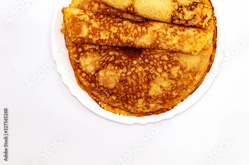 Wallpaper Mural On a white background in a white round plate are festive pancakes fried in sunflower oil Torontodigital.ca