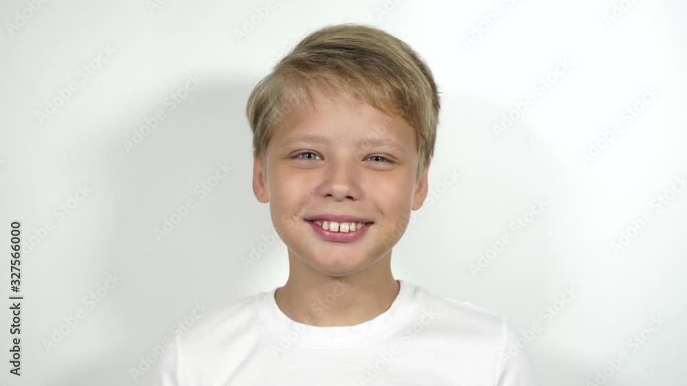Closeup view 4k video portrait of one cute happy smiling caucasian young kid isolated on white backround. Closeup view 4k video portrait of one cute happy smiling caucasian young kid isolated on white backround.