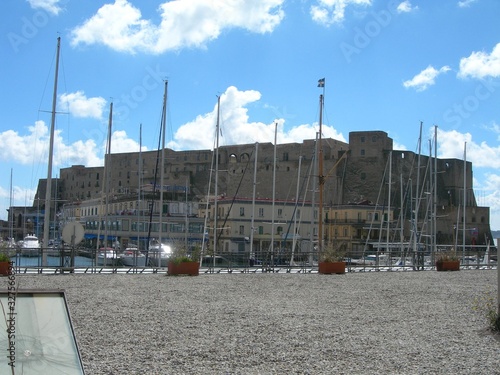 Naples –  Castel dell'ovo fortress stands on the tuff island of Megaride surrounded by water and connected to the land by a thin rocky isthmus photo