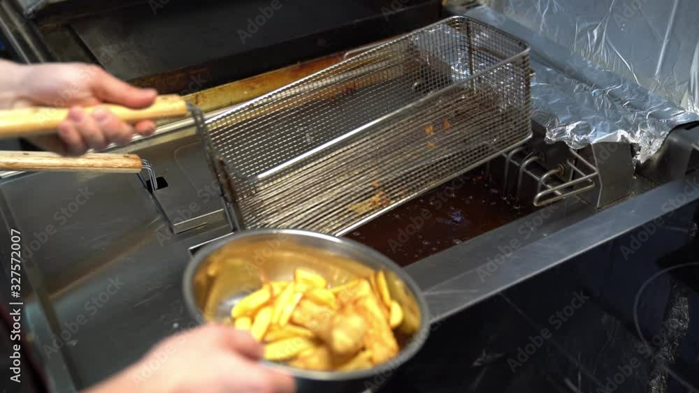 Ready snacks spilling out of the fryer. Fast food. Ready snacks spilling out of the fryer. Fast food.