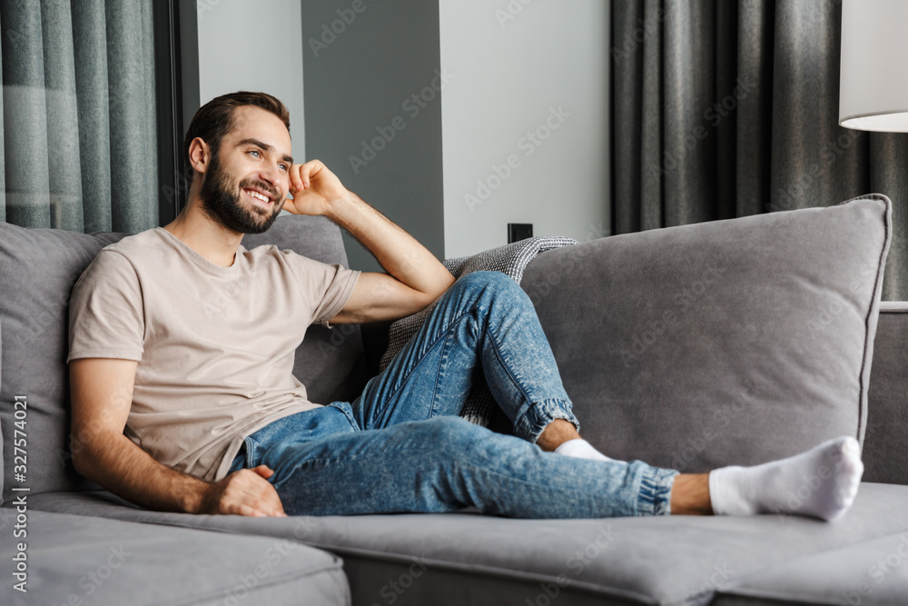 Handsome optimistic young positive man indoors at home. Handsome optimistic young positive man indoors at home.