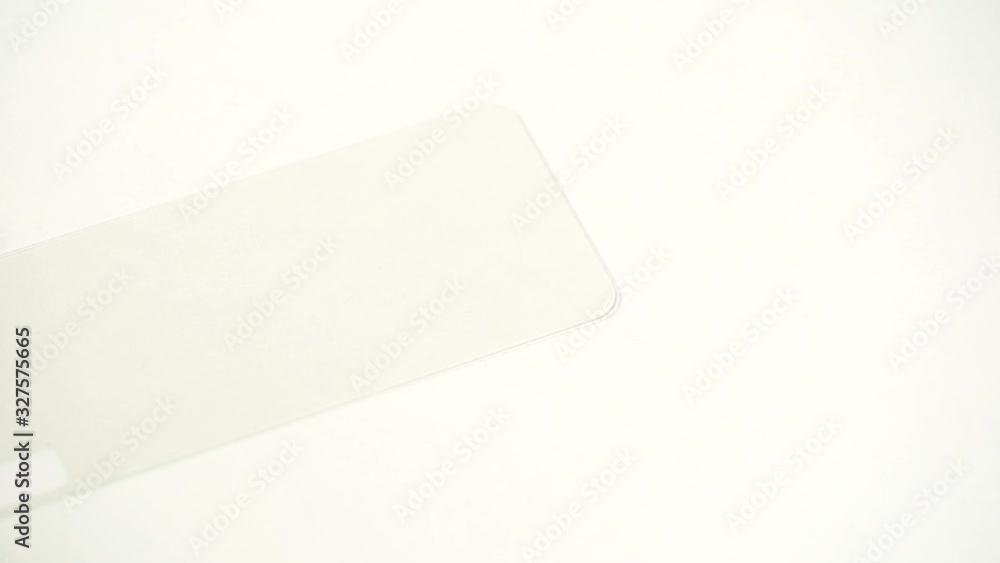 Closeup view of new protector glass for screens of modern smartphones. Closeup view of new protector glass for screens of modern smartphones.