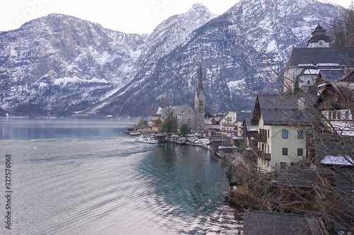 Hallstatt heritage village landmark for tourism sightseeing check point. Houses with tradition style old European architecture building on right side and clear lake on left. During cold winter season.