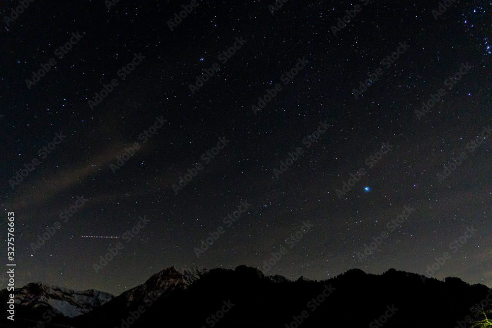 the stars and the night sky seen from the italian alps, during a fantastic winter night, near the town of Branzi, Italy - February 2020.