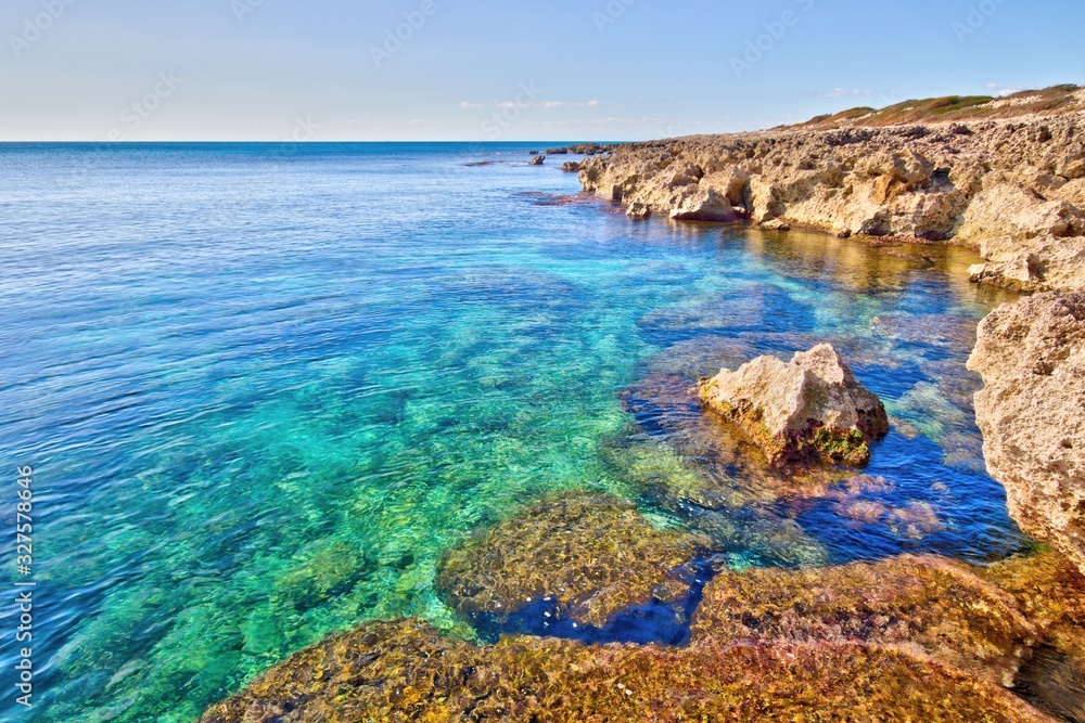 Rocky coastline and turquoise transparent sea in the Salento coast near Taranto, Puglia, Italy