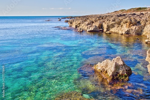 Fototapeta Naklejka Na Ścianę i Meble -  Rocky coastline and turquoise transparent sea in the Salento coast near Taranto, Puglia, Italy