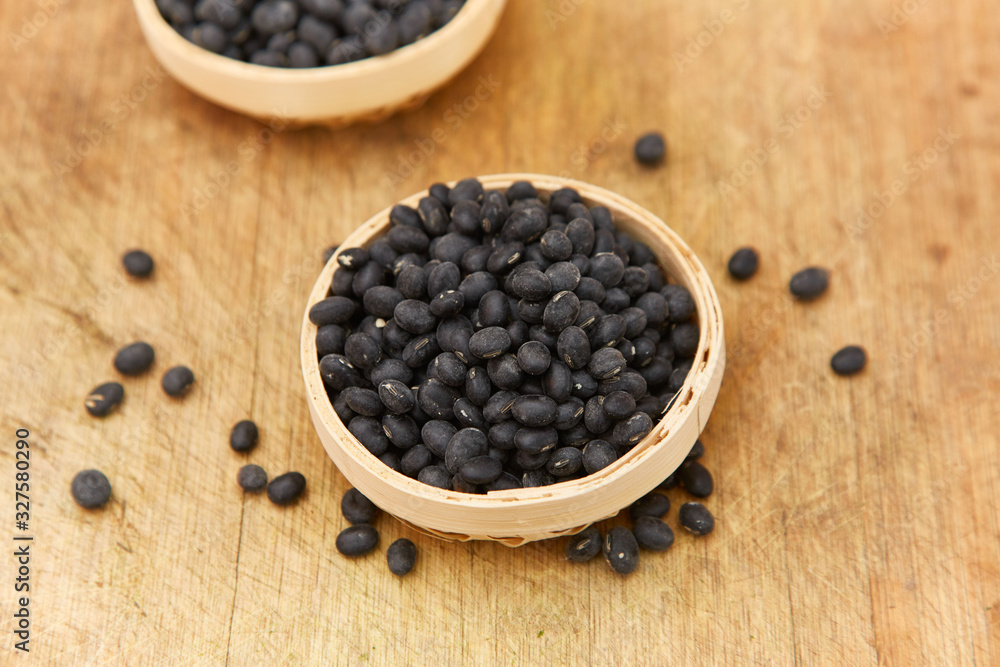 A pile of black beans in the bamboo basket A pile of black beans in the bamboo basket