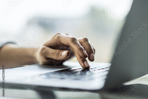 Female finger presses a button on a laptop keyboard, business and technology concept. Close up © Pixels Hunter