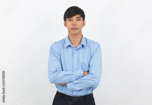 Young handsome asian business man looking to camera with arms crossed isolated on white background.