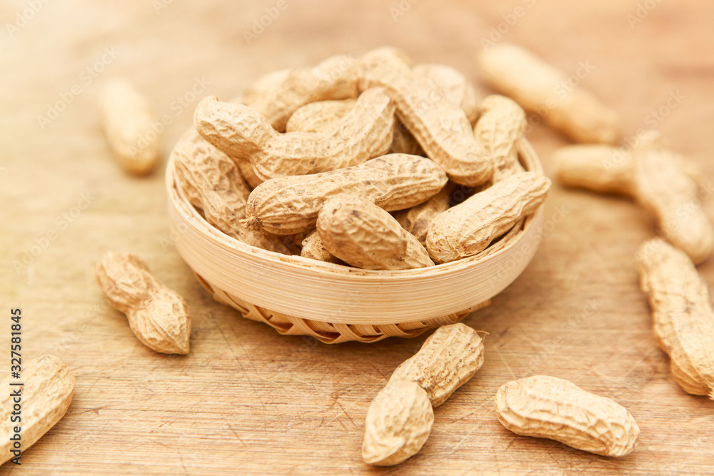 A pile of peanuts in a bamboo basket A pile of peanuts in a bamboo basket
