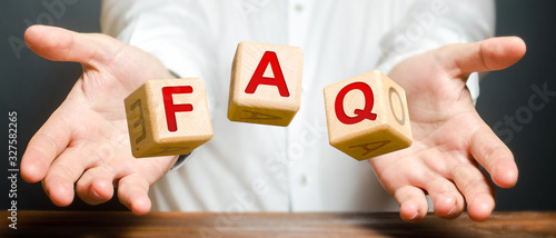 Cubes thrown by a man make word abbreviation acronym FAQ (frequently asked questions). Instructions and rules. Avoid frequent errors. Convenient form of answers explanations for users and customers.