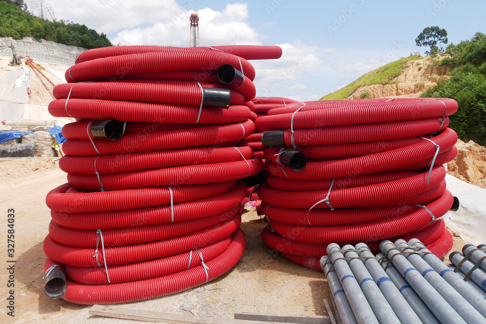 KUALA LUMPUR, MALAYSIA -FEBRUARY 6, 2019: HDPE corrugated pipe with double wall strength at the construction site. Used to protect underground cable. KUALA LUMPUR, MALAYSIA -FEBRUARY 6, 2019: HDPE corrugated pipe with double wall strength at the construction site. Used to protect underground cable.