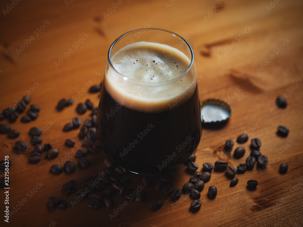 Craft beer coffee stout in a glass on a wooden table - obrazy, fototapety, plakaty 