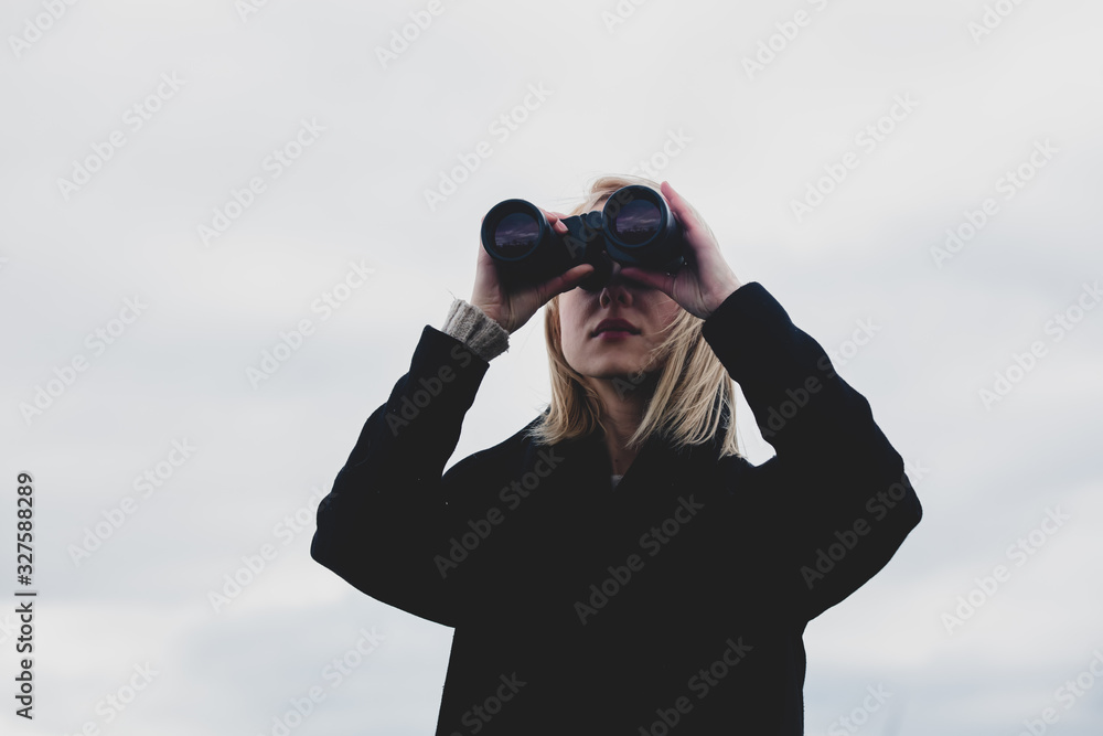 Style woman with binoculars at outdoor