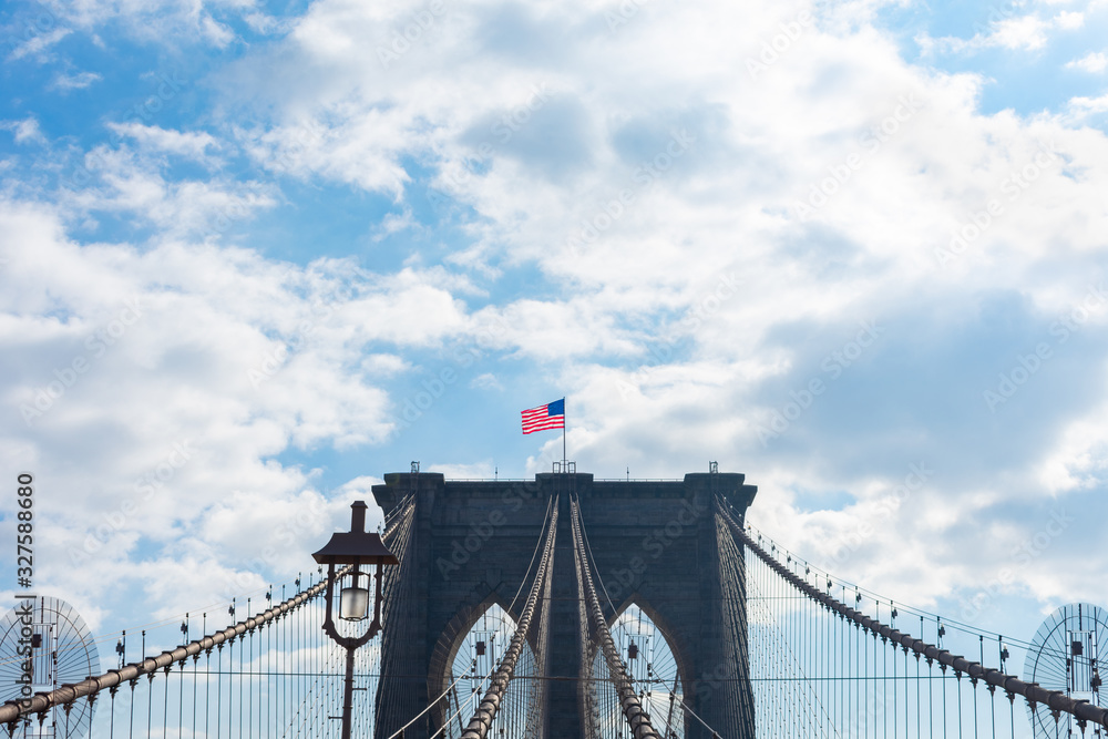 Fototapeta premium Arches on the Brooklyn Bridge with an American Flag in New York City
