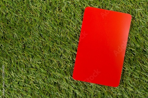 Soccer sports referee red cards on grass background flat lay from above