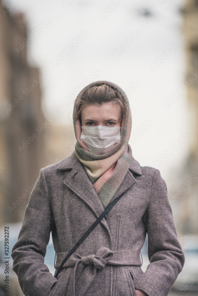 Young woman in a protective mask against viruses on the street Young woman in a protective mask against viruses on the street
