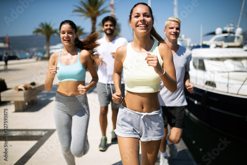 Healthy group of friends running and enjoying friend time together