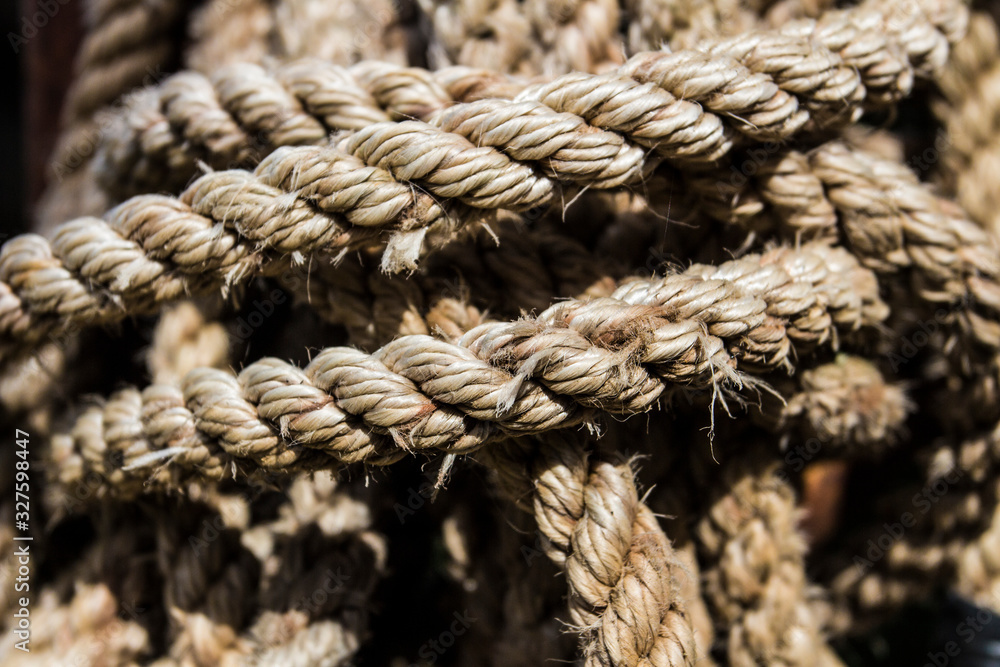 Close-up, an old twisted, tied, knotted rope Close-up, an old twisted, tied, knotted rope
