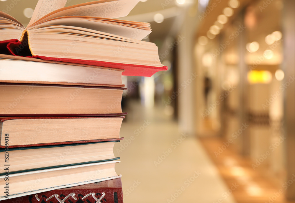 Collection of different books against blurred background, space for text Collection of different books against blurred background, space for text
