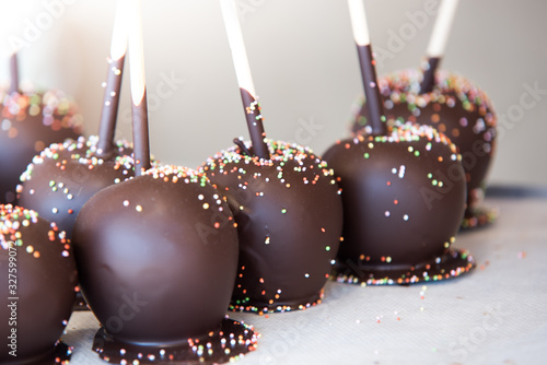 Chocolate apples, chocolate covered fruits at the market stall in the medieval fair