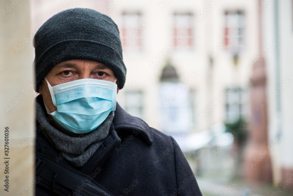 Portrait of man with medical mask to protect against the corona virus in the street Portrait of man with medical mask to protect against the corona virus in the street