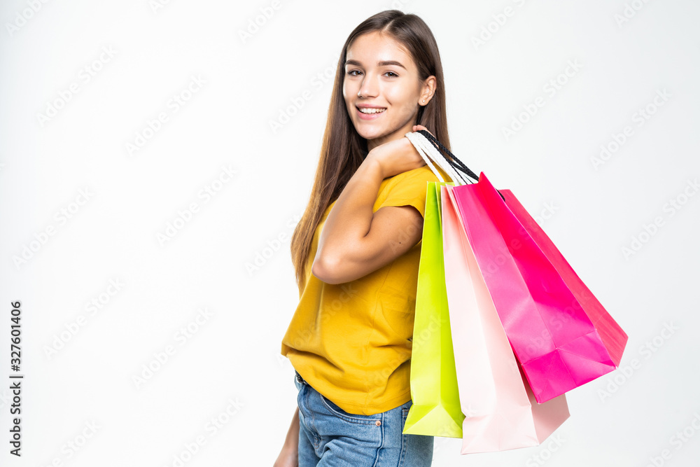 Portrait of young happy smiling woman with shopping bags over white background Portrait of young happy smiling woman with shopping bags over white background