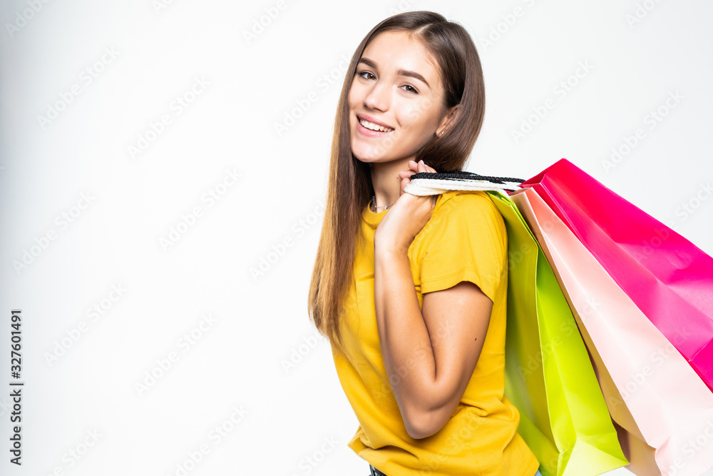 Portrait of young happy smiling woman with shopping bags over white background Portrait of young happy smiling woman with shopping bags over white background