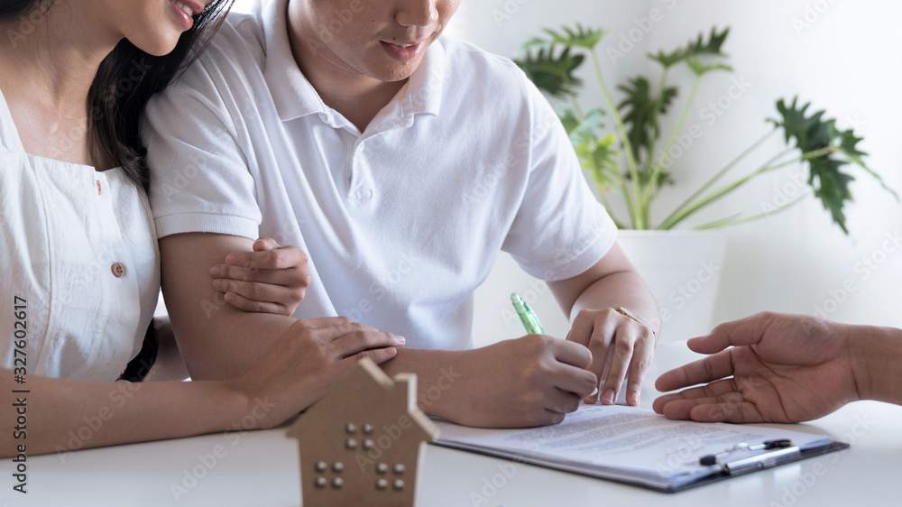 Real estate concept, Real estate agent proposes to client to sign contract, Signing the agreement form to buy a house, Moving house or renting real estate. Real estate concept, Real estate agent proposes to client to sign contract, Signing the agreement form to buy a house, Moving house or renting real estate.