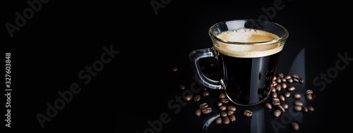 black coffee with roaseted beans on black background © K.Miłkowski