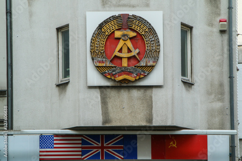 Canvas-taulu The detail of the sign of the German democratic republic on one of the houses at Check point Charlie in Berlin