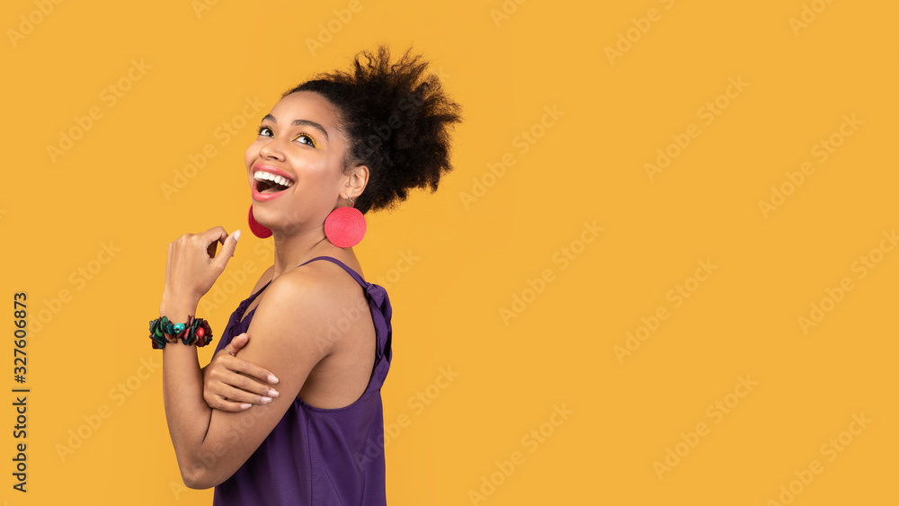 Smiling black woman looking up at studio Smiling black woman looking up at studio
