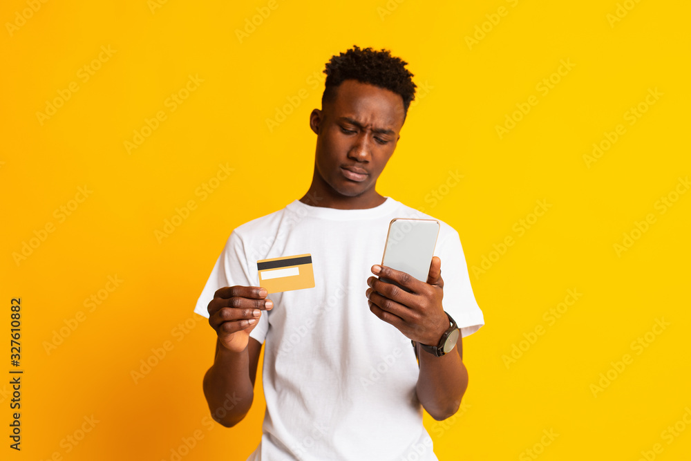 Young african man cannot understand how to pay online Young african man cannot understand how to pay online