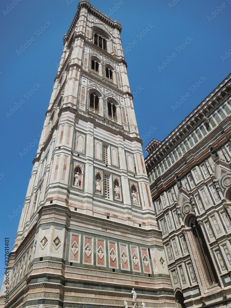 Giotto bell tower, a closeup shot from the ground looking up, detailing of the marble carvings and intricate decoration, Florence, Italy