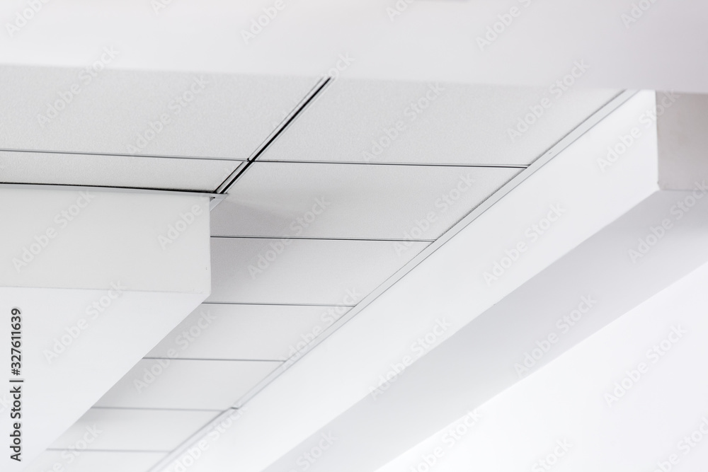 multi-level ceiling with three-dimensional protrusions and a suspended tiled ceiling, perspective on the ceiling. multi-level ceiling with three-dimensional protrusions and a suspended tiled ceiling, perspective on the ceiling.