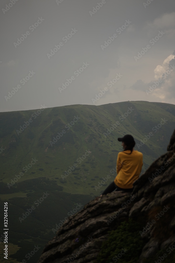 silhouette of woman on top of mountain
