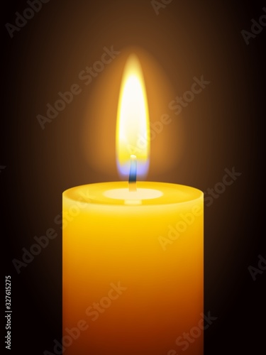 Realistic burning yellow candle on dark background