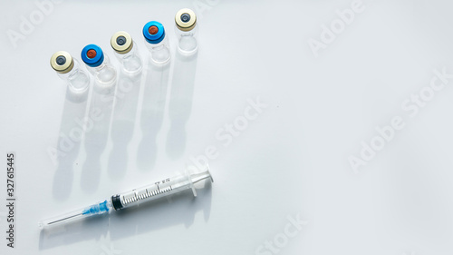 Vaccines bottles and syringe. Medical objects.