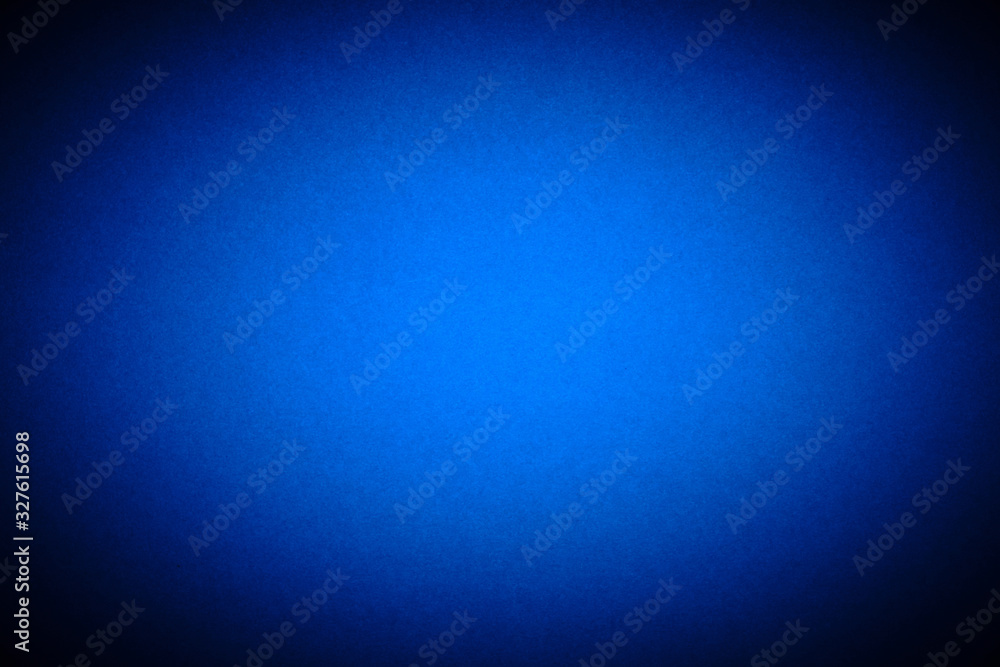 Bright blue background with vignetting. The texture of the cardboard. Bright blue background with vignetting. The texture of the cardboard.