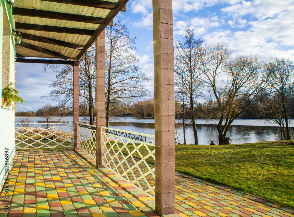 Fototapeta premium Beautiful wooden villa with a green patio. Minsk, Belarus - March 01 2020
