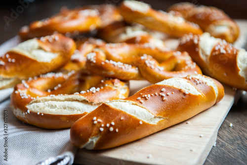 Closeup photo of handmade lye bun and pretzel in bakery