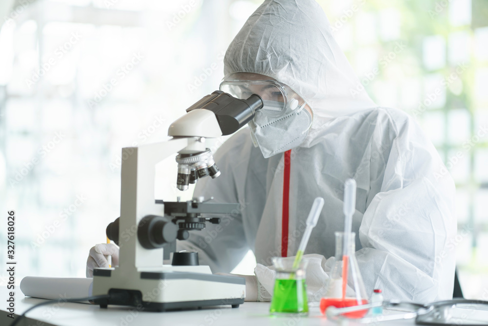 Medical scientist analyzing microscope slides in research lab for 2019-nCoV vaccine or serum. Medical scientist analyzing microscope slides in research lab for 2019-nCoV vaccine or serum.