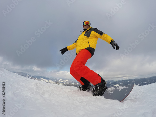 Man snowboarding at ski resort. Winter vacation