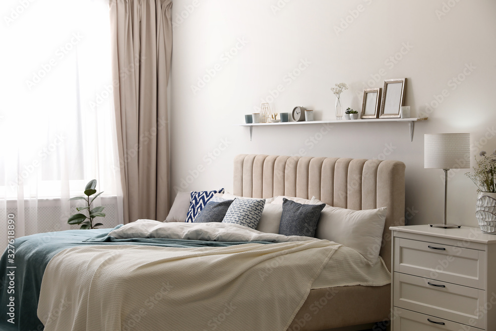 Fototapeta premium Comfortable bed with pillows in room. Stylish interior design