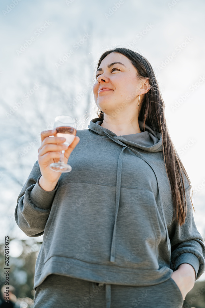 Beautiful woman enjoying glass of rose wine at picnic in park outdoors. Spring lifestyle. Leisure outdoors weekend activity. Contemplation Beautiful woman enjoying glass of rose wine at picnic in park outdoors. Spring lifestyle. Leisure outdoors weekend activity. Contemplation