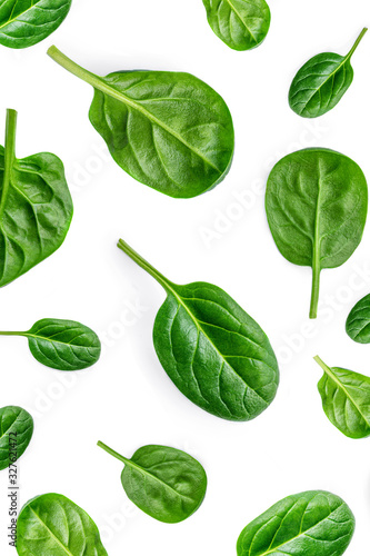 Creative layout made of Fresh spinach leaves isolated on white background. Pattern. Green baby spinach Flat lay.