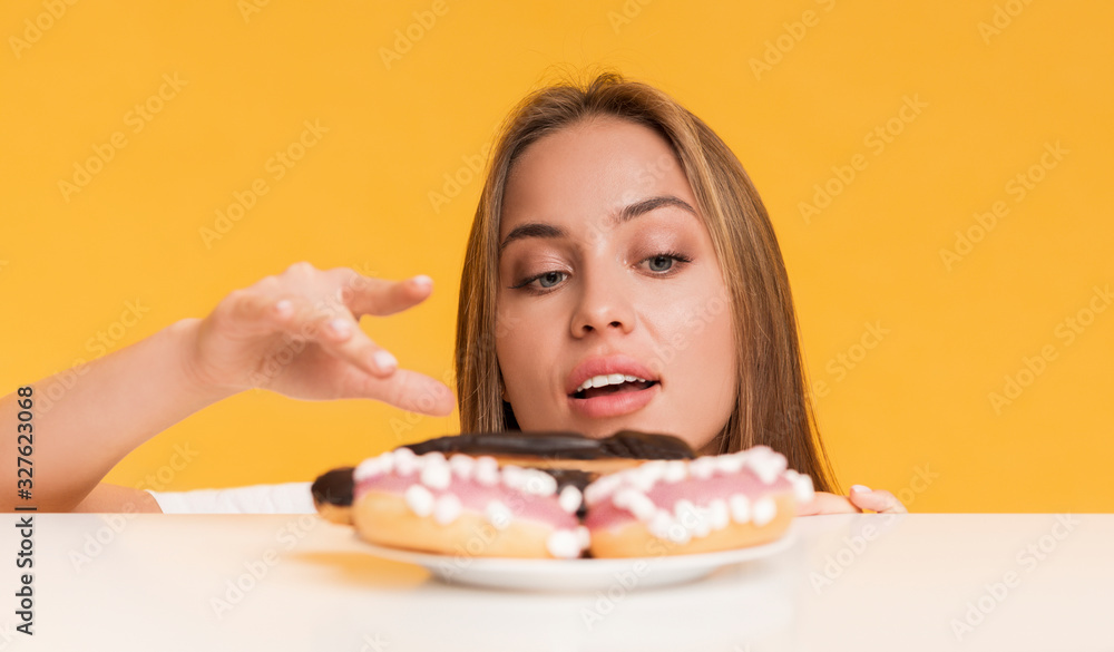 Hungry Girl Taking Sweets From Plate, Fancy About Unhealthy Junk Food Hungry Girl Taking Sweets From Plate, Fancy About Unhealthy Junk Food