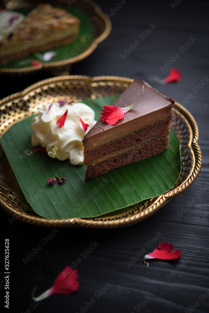 Piece of chocolate cake on wooden table Piece of chocolate cake on wooden table