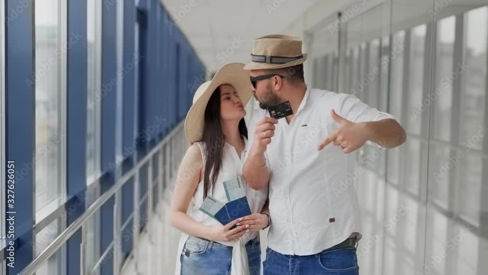 the couple shows their passports and credit card as easily the couple shows their passports and credit card as easily