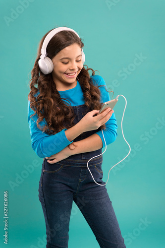 Modern gadgets. Music app. Audio book. Educative content. Study language audio lessons. Girl listen music modern headphones and smartphone. Listen for free. Music subscription. Enjoy music concept